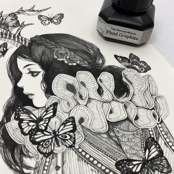 A picture of a side profile of a womans face and butterflies around her that was made using the Kuretake ZIG Fluid Graphite. You can see part of a bottle at the top of the frame.