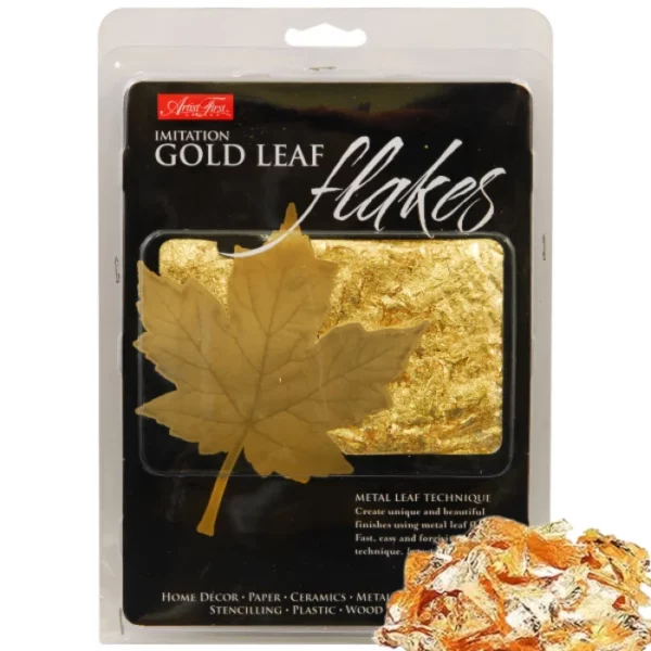 A single pack of AFC Gold Imitation Leaf Flakes is shown in the center of the frame, with some loose flakes overlapping the pack, in the bottom right hand corner of the frame. The pack is a plastic hang pack with a black printed label as the cover that has a small window so you can see the colour of the flakes inside the pack. On a white background.