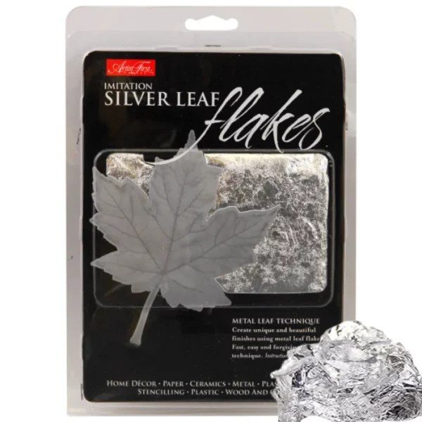 A single pack of AFC Silver Imitation Leaf Flakes is shown in the center of the frame, with some loose flakes overlapping the pack, in the bottom right hand corner of the frame. The pack is a plastic hang pack with a black printed label as the cover that has a small window so you can see the colour of the flakes inside the pack. On a white background.