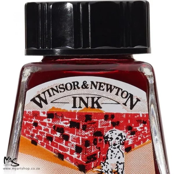 A close up of a single bottle of Brick Red Winsor & Newton Drawing Ink. The bottom of the bottle is cut off by the frame. The bottle is clear glass so you can see the colour of the ink inside, with a black screw on plastic lid. There is a label on the front of the bottle with the brand logo.