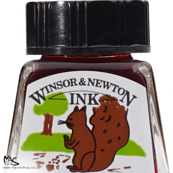 A close up of a single bottle of Burnt Sienna Winsor & Newton Drawing Ink. The bottom of the bottle is cut off by the frame. The bottle is clear glass so you can see the colour of the ink inside, with a black screw on plastic lid. There is a label on the front of the bottle with the brand logo.