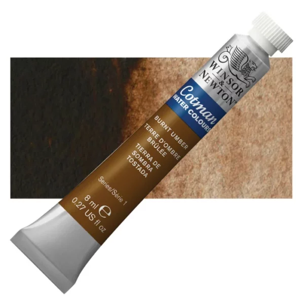 A single Burnt Umber Winsor and Newton Cotman Watercolour 8ml Tube is shown diagonally across the frame. The back of the tube is facing the bottom left hand corner of the frame and the lid of the tube is facing the top, right hand corner of the frame. The tube is silver and the Winsor and Newton logo is printed at the top of the tube. There is a blue band below the logo and the words 'Cotman Watercolour' are printed on the blue band in white. Then there is a large colour band around the base of the tube that denotes the colour of the paint. The tube colour and paint properties are indicated on this colour band in black text. The tube has a white, plastic screw on cap. There is a rectangular colour swatch behind the tube that shows how the colour works on a gradient scale. The entire image is center of the frame and on a white background.