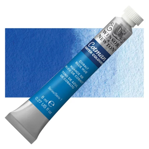 A single Cobalt Blue Hue Winsor and Newton Cotman Watercolour 8ml Tube is shown diagonally across the frame. The back of the tube is facing the bottom left hand corner of the frame and the lid of the tube is facing the top, right hand corner of the frame. The tube is silver and the Winsor and Newton logo is printed at the top of the tube. There is a blue band below the logo and the words 'Cotman Watercolour' are printed on the blue band in white. Then there is a large colour band around the base of the tube that denotes the colour of the paint. The tube colour and paint properties are indicated on this colour band in black text. The tube has a white, plastic screw on cap. There is a rectangular colour swatch behind the tube that shows how the colour works on a gradient scale. The entire image is center of the frame and on a white background.