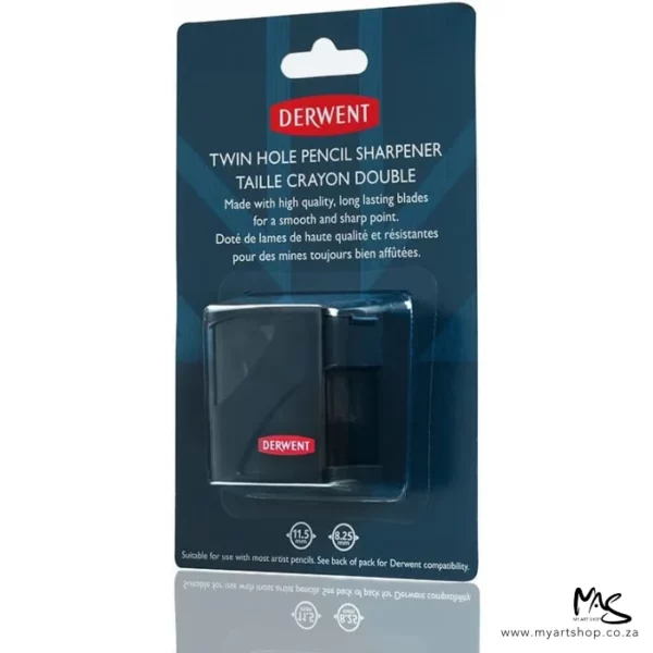 A Derwent Twin Hole Pencil Sharpener is shown in it's hangpack packaging in the center of the frame. The sharpener can be seen through the clear plastic packaging which is attached to a printed cardboard backing. The sharpener is black with a red Derwent logo printed at the bottom. The cardboard packaging is blue with white text and the Derwent logo. Theere is a shadow of the packaging directly underneath it. The image is center of the frame on a white background.