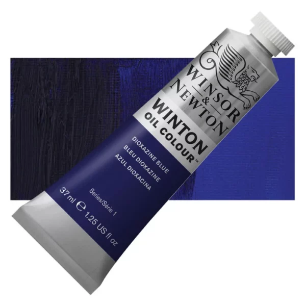 A tube of Dioxazine Blue Winsor and Newton Winton Oil Paint 37ml is shown diagonally, across the center of the frame. The tube is a silver colour and has a white screw on, plastic lid. The Winsor and Newton logo is printed at the top of the tube and there is a white band printed across the tube, below the logo, that has the words 'Winton Oil Colour' written on it. Below that is a colour band printed across the tube that has black text describing the product colour and paint properties. There is a rectangular colour swatch behind the tube that shows the colour of the paint. It lays horizontally across the top third of the frame. The image is center of the frame and on a white background.