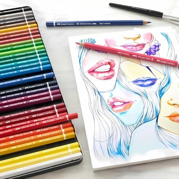 A promotional image for Faber Castell Albrecht Durer Water Colour Pencils. It is a close up image that is cut off by the frame. There is part of a set of pencils seen coming out of the left hand side of the frame and a sketch pad with an abstract drawing of faces on it that were made using the pencils.