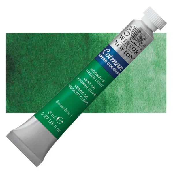 A single Hookers Green Light Winsor and Newton Cotman Watercolour 8ml Tube is shown diagonally across the frame. The back of the tube is facing the bottom left hand corner of the frame and the lid of the tube is facing the top, right hand corner of the frame. The tube is silver and the Winsor and Newton logo is printed at the top of the tube. There is a blue band below the logo and the words 'Cotman Watercolour' are printed on the blue band in white. Then there is a large colour band around the base of the tube that denotes the colour of the paint. The tube colour and paint properties are indicated on this colour band in black text. The tube has a white, plastic screw on cap. There is a rectangular colour swatch behind the tube that shows how the colour works on a gradient scale. The entire image is center of the frame and on a white background.