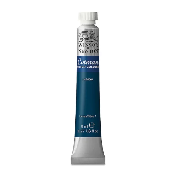 A single Indigo Winsor and Newton Cotman Watercolour 8ml Tube is shown vertically in the center of the frame. The tube is silver and the Winsor and Newton logo is printed at the top of the tube. There is a blue band below the logo and the words 'Cotman Watercolour' are printed on the blue band in white. Then there is a large colour band around the base of the tube that denotes the colour of the paint. The tube colour and paint properties are indicated on this colour band in black text. The tube has a white, plastic screw on cap. The image is center of the frame and on a white background.