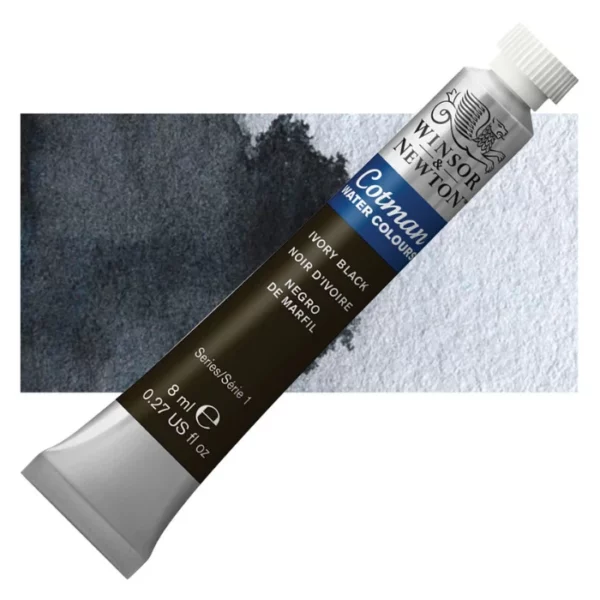 A single Ivory Black Winsor and Newton Cotman Watercolour 8ml Tube is shown diagonally across the frame. The back of the tube is facing the bottom left hand corner of the frame and the lid of the tube is facing the top, right hand corner of the frame. The tube is silver and the Winsor and Newton logo is printed at the top of the tube. There is a blue band below the logo and the words 'Cotman Watercolour' are printed on the blue band in white. Then there is a large colour band around the base of the tube that denotes the colour of the paint. The tube colour and paint properties are indicated on this colour band in black text. The tube has a white, plastic screw on cap. There is a rectangular colour swatch behind the tube that shows how the colour works on a gradient scale. The entire image is center of the frame and on a white background.