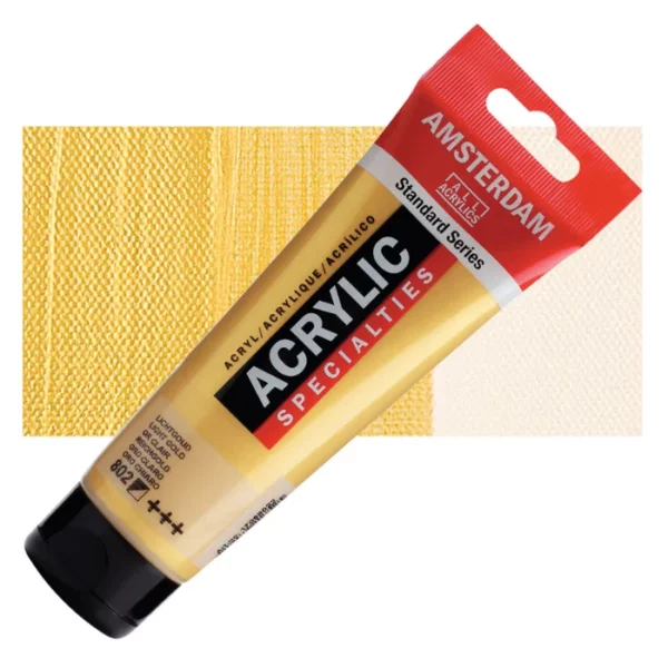 A single tube of Light Gold Amsterdam Acrylic Paint 120ml is shown diagonally across the center of the frame. The tube is made of a clear plastic and has a red band at the end of the tube with a hole so it can hang. The tube has a black, plastic flip top cap, that the bottle stands on. There is black text on the body of the tube describing the product colour and details. The colour of the paint can be seen through the tube. There is a rectangular colour swatch of the paint, behind the tube. The swatch shows the colour in different gradient's. The image is center of the frame and on a white background.