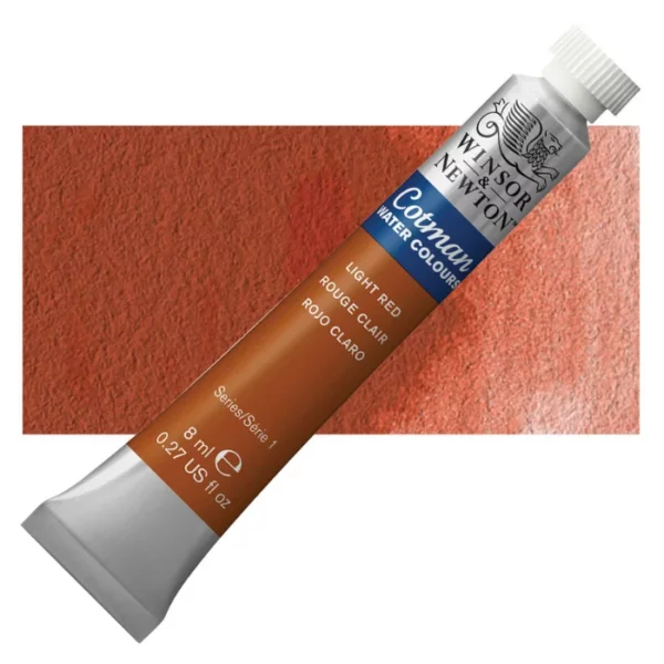 A single Light Red Winsor and Newton Cotman Watercolour 8ml Tube is shown diagonally across the frame. The back of the tube is facing the bottom left hand corner of the frame and the lid of the tube is facing the top, right hand corner of the frame. The tube is silver and the Winsor and Newton logo is printed at the top of the tube. There is a blue band below the logo and the words 'Cotman Watercolour' are printed on the blue band in white. Then there is a large colour band around the base of the tube that denotes the colour of the paint. The tube colour and paint properties are indicated on this colour band in black text. The tube has a white, plastic screw on cap. There is a rectangular colour swatch behind the tube that shows how the colour works on a gradient scale. The entire image is center of the frame and on a white background.