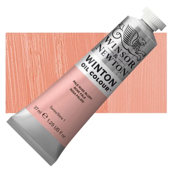 A tube of Pale Rose Blush Winsor and Newton Winton Oil Paint 37ml is shown diagonally, across the center of the frame. The tube is a silver colour and has a white screw on, plastic lid. The Winsor and Newton logo is printed at the top of the tube and there is a white band printed across the tube, below the logo, that has the words 'Winton Oil Colour' written on it. Below that is a colour band printed across the tube that has black text describing the product colour and paint properties. There is a rectangular colour swatch behind the tube that shows the colour of the paint. It lays horizontally across the top third of the frame. The image is center of the frame and on a white background.