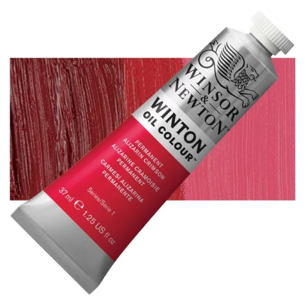 A tube of Permanent Alizarin Crimson Winsor and Newton Winton Oil Paint 37ml is shown diagonally, across the center of the frame. The tube is a silver colour and has a white screw on, plastic lid. The Winsor and Newton logo is printed at the top of the tube and there is a white band printed across the tube, below the logo, that has the words 'Winton Oil Colour' written on it. Below that is a colour band printed across the tube that has black text describing the product colour and paint properties. There is a rectangular colour swatch behind the tube that shows the colour of the paint. It lays horizontally across the top third of the frame. The image is center of the frame and on a white background.