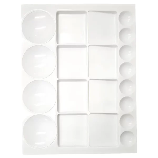 A Prime Art Plastic Palette 20 Well Large Rectangular is shown, vertically in the center of the frame. The palette is made of a white plastic and has 20 wells to hold colour. There are 8 small, circular wells, 4 large wells and 8 square wells in the center of the palette. The image is center of the frame and on a white background.