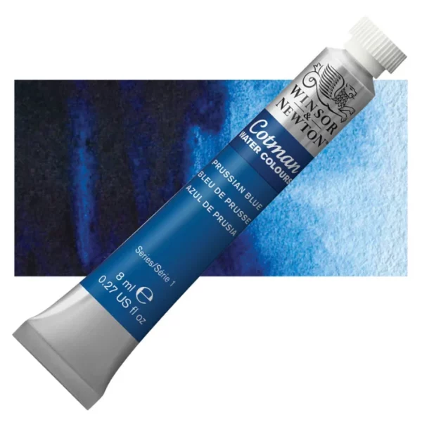 A single Prussian Blue Winsor and Newton Cotman Watercolour 8ml Tube is shown diagonally across the frame. The back of the tube is facing the bottom left hand corner of the frame and the lid of the tube is facing the top, right hand corner of the frame. The tube is silver and the Winsor and Newton logo is printed at the top of the tube. There is a blue band below the logo and the words 'Cotman Watercolour' are printed on the blue band in white. Then there is a large colour band around the base of the tube that denotes the colour of the paint. The tube colour and paint properties are indicated on this colour band in black text. The tube has a white, plastic screw on cap. There is a rectangular colour swatch behind the tube that shows how the colour works on a gradient scale. The entire image is center of the frame and on a white background.