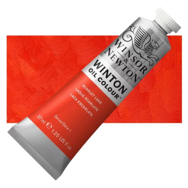 A tube of Scarlet Lake Winsor and Newton Winton Oil Paint 37ml is shown diagonally, across the center of the frame. The tube is a silver colour and has a white screw on, plastic lid. The Winsor and Newton logo is printed at the top of the tube and there is a white band printed across the tube, below the logo, that has the words 'Winton Oil Colour' written on it. Below that is a colour band printed across the tube that has black text describing the product colour and paint properties. There is a rectangular colour swatch behind the tube that shows the colour of the paint. It lays horizontally across the top third of the frame. The image is center of the frame and on a white background.