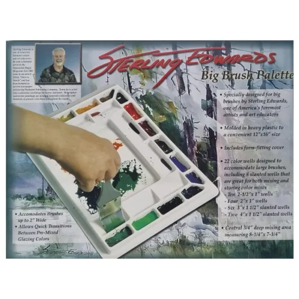 A box containing a Sterling Edwards Big Brush Palette is shown, horizontally, across the center of the frame. The box has a picture of the palette and a persons hand dipping a paint brush into the palette. There is text describing the size and details of the product. On a white background.