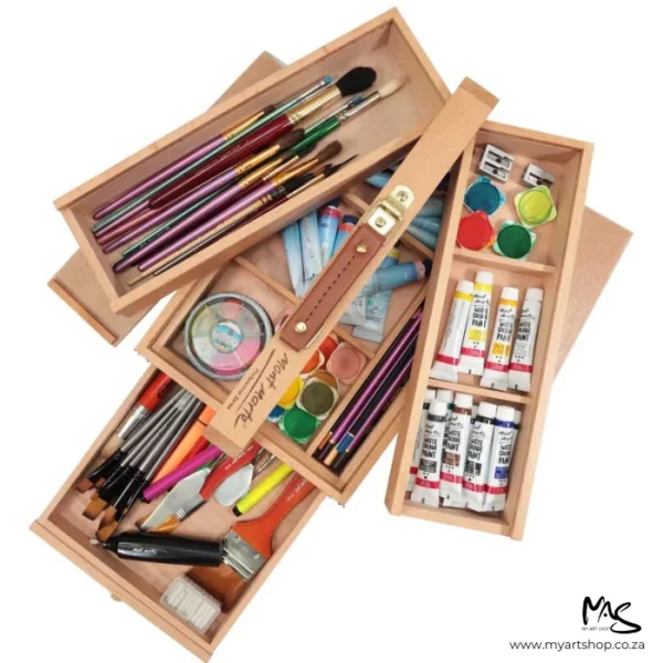 A top view of an open Mont Marte Signature Multi Purpose Art Box with art supplies inside the box. You can see the 3 tiers of storage and the box is filled with paints, brushes, tools and more. The box is angled across the frame and on a white background.