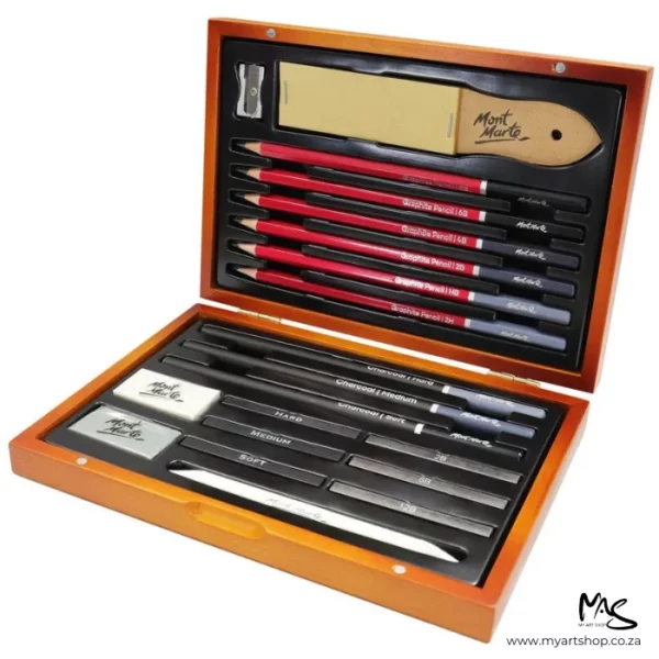 There is a Mont Marte Signature Sketching Set in a Wooden Box that is open, in the center of the frame. The hinged box lid is open and you can see the 21 pieces in the set. They are neatly aligned next to each other and include pencils, a paper stump, a kneadable eraser, a sanding block, charcoals and more. The image is center of the frame and on a white background.