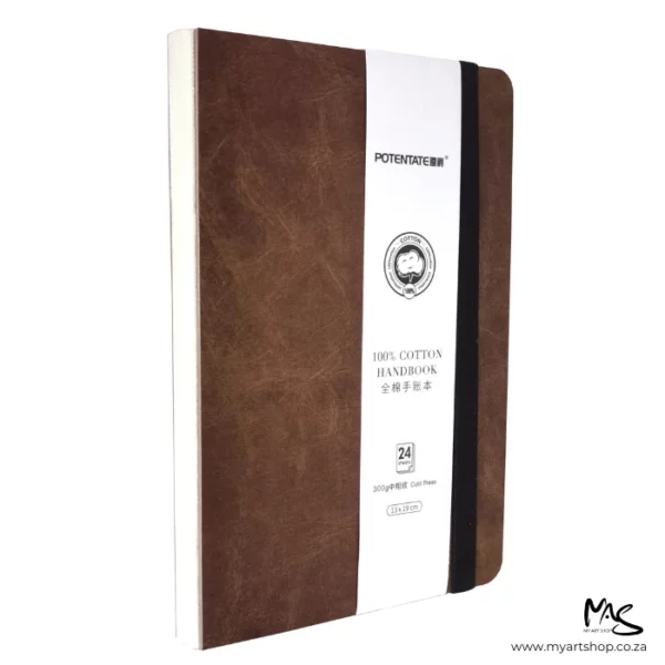 The image shows a Cold Press Potentate Watercolour Handbook with a Brown Cover at an angled profile so you can see the stitched spine and front cover, in the center of the frame. The image is on a white background