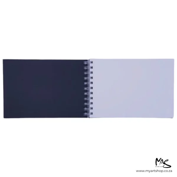 A single Prime Art Academy Sketch Book Landscape is shown with the front cover open, across the center of the frame. The cover is black and the spiral bind is black and the pages are white. The image is center of the frame and on a white background.