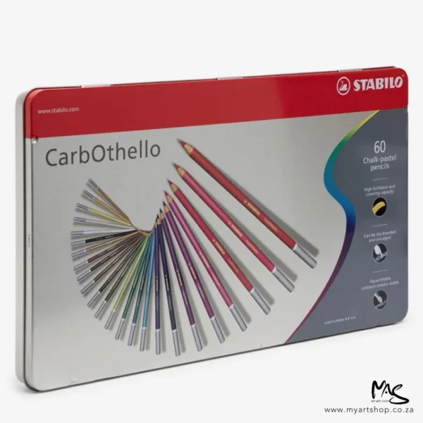 A Stabilo CarbOthello Chalk Pastel Pencil Set of 60 pencils is shown diagonally across the center of the frame. The tin shows an image of the pencils on the front and there is text describing the set. The image is on a white background.