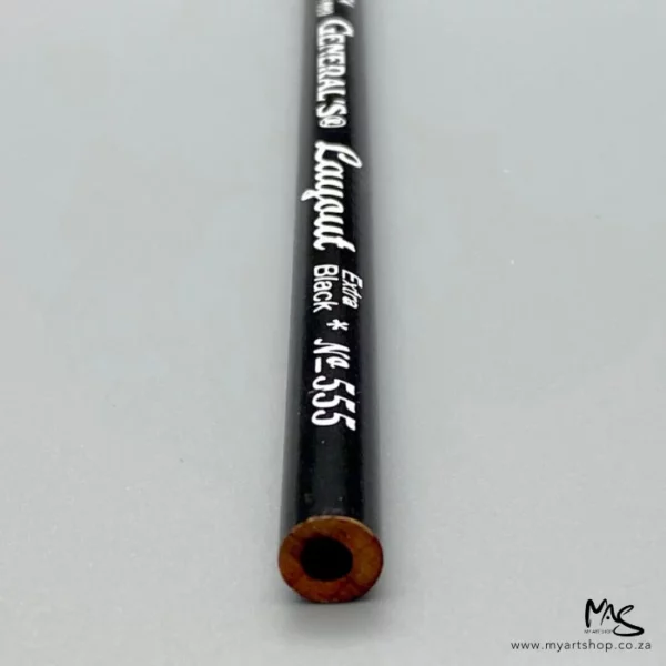The back end of a single General's Layout Extra Black Pencil is shown in the center of the frame. The pencil has a black barrel with text on the barrel. The image is on a light grey background.