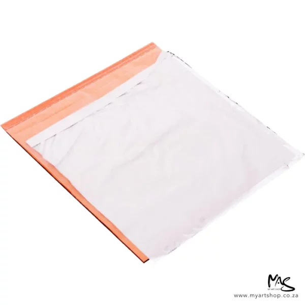 An open pack of Mont Marte Imitation Silver Leaf can be seen diagonally in the center of the frame. The sheets are silver and there is a peach coloured paper between the sheets. The image is on a white background.