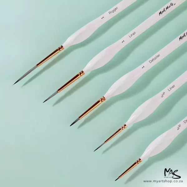 A close up of the 5 loose brushes that come in the Mont Marte Detail and Liner Brush Set. The brushes are coming into the frame diagonally from the right hand side. They have white handles and taklon bristles and are on a teal background.