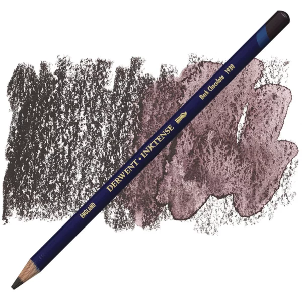 A single Dark Chocolate Derwent Inktense Colour Pencil is shown diagonally across the center of the frame. The pencil is pointing with it's lead facing towards the bottom left hand corner. The barrel of the pencil is blue and the end of the pencil is colour dipped to match the colour of the lead for easy identification. There is text down the barrel of the pencil with the colour name and brand name. There is a colour swatch of the pencil in the background, that runs horizontally across the center of the frame. The image is center of the frame and on a white background.