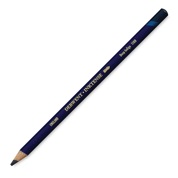 A single Deep Indigo Derwent Inktense Colour Pencil is shown diagonally across the center of the frame. The pencil is pointing with it's lead facing towards the bottom left hand corner. The barrel of the pencil is blue and the end of the pencil is colour dipped to match the colour of the lead for easy identification. There is text down the barrel of the pencil with the colour name and brand name. On a white background.