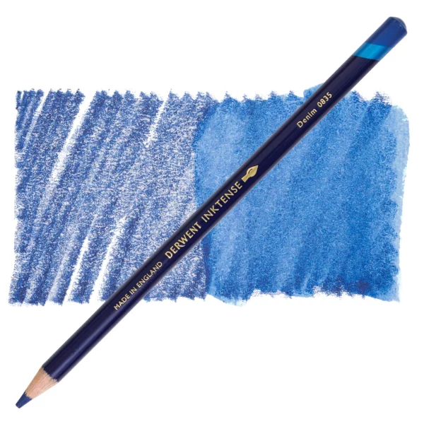 A single Denim Derwent Inktense Colour Pencil is shown diagonally across the center of the frame. The pencil is pointing with it's lead facing towards the bottom left hand corner. The barrel of the pencil is blue and the end of the pencil is colour dipped to match the colour of the lead for easy identification. There is text down the barrel of the pencil with the colour name and brand name. There is a colour swatch of the pencil in the background, that runs horizontally across the center of the frame. The image is center of the frame and on a white background.