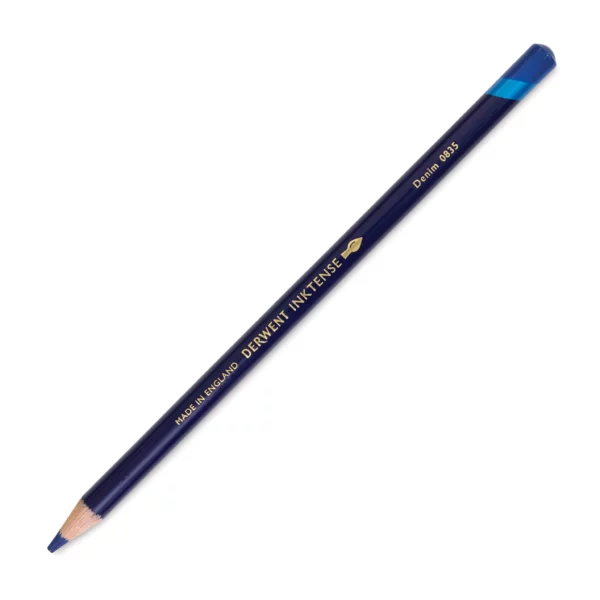 A single Denim Derwent Inktense Colour Pencil is shown diagonally across the center of the frame. The pencil is pointing with it's lead facing towards the bottom left hand corner. The barrel of the pencil is blue and the end of the pencil is colour dipped to match the colour of the lead for easy identification. There is text down the barrel of the pencil with the colour name and brand name. On a white background.