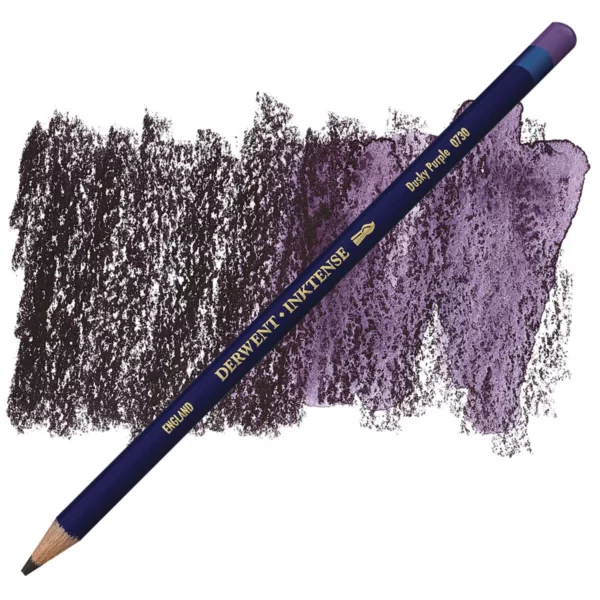 A single Dusky Purple Derwent Inktense Colour Pencil is shown diagonally across the center of the frame. The pencil is pointing with it's lead facing towards the bottom left hand corner. The barrel of the pencil is blue and the end of the pencil is colour dipped to match the colour of the lead for easy identification. There is text down the barrel of the pencil with the colour name and brand name. There is a colour swatch of the pencil in the background, that runs horizontally across the center of the frame. The image is center of the frame and on a white background.