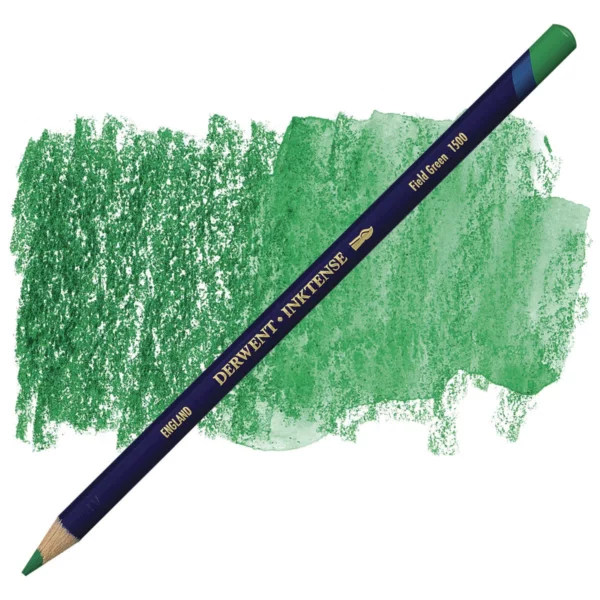 A single Field Green Derwent Inktense Colour Pencil is shown diagonally across the center of the frame. The pencil is pointing with it's lead facing towards the bottom left hand corner. The barrel of the pencil is blue and the end of the pencil is colour dipped to match the colour of the lead for easy identification. There is text down the barrel of the pencil with the colour name and brand name. There is a colour swatch of the pencil in the background, that runs horizontally across the center of the frame. The image is center of the frame and on a white background.