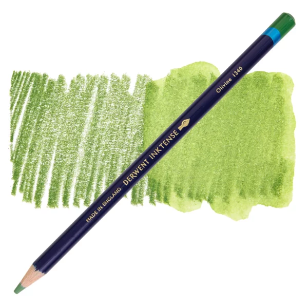 A single Olivine Derwent Inktense Colour Pencil is shown diagonally across the center of the frame. The pencil is pointing with it's lead facing towards the bottom left hand corner. The barrel of the pencil is blue and the end of the pencil is colour dipped to match the colour of the lead for easy identification. There is text down the barrel of the pencil with the colour name and brand name. There is a colour swatch of the pencil in the background, that runs horizontally across the center of the frame. The image is center of the frame and on a white background.