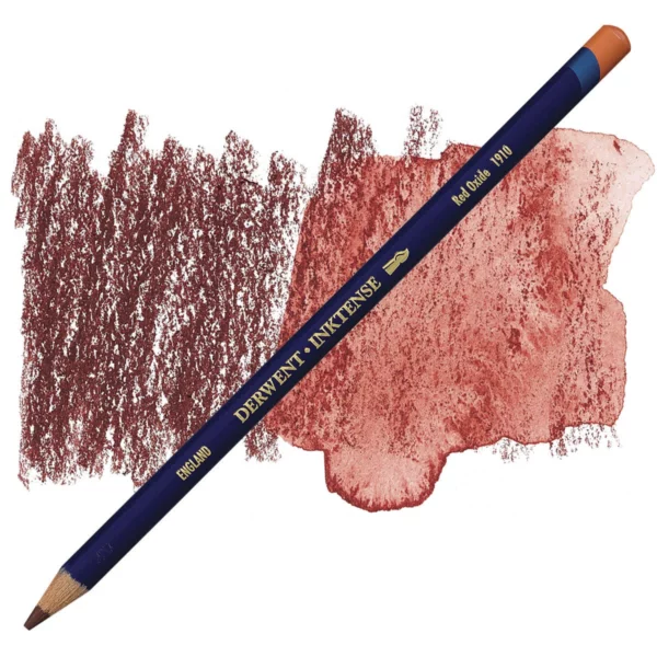 A single Red Oxide Derwent Inktense Colour Pencil is shown diagonally across the center of the frame. The pencil is pointing with it's lead facing towards the bottom left hand corner. The barrel of the pencil is blue and the end of the pencil is colour dipped to match the colour of the lead for easy identification. There is text down the barrel of the pencil with the colour name and brand name. There is a colour swatch of the pencil in the background, that runs horizontally across the center of the frame. The image is center of the frame and on a white background.