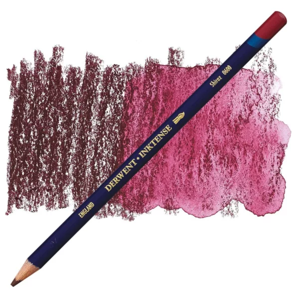 A single Shiraz Derwent Inktense Colour Pencil is shown diagonally across the center of the frame. The pencil is pointing with it's lead facing towards the bottom left hand corner. The barrel of the pencil is blue and the end of the pencil is colour dipped to match the colour of the lead for easy identification. There is text down the barrel of the pencil with the colour name and brand name. There is a colour swatch of the pencil in the background, that runs horizontally across the center of the frame. The image is center of the frame and on a white background.