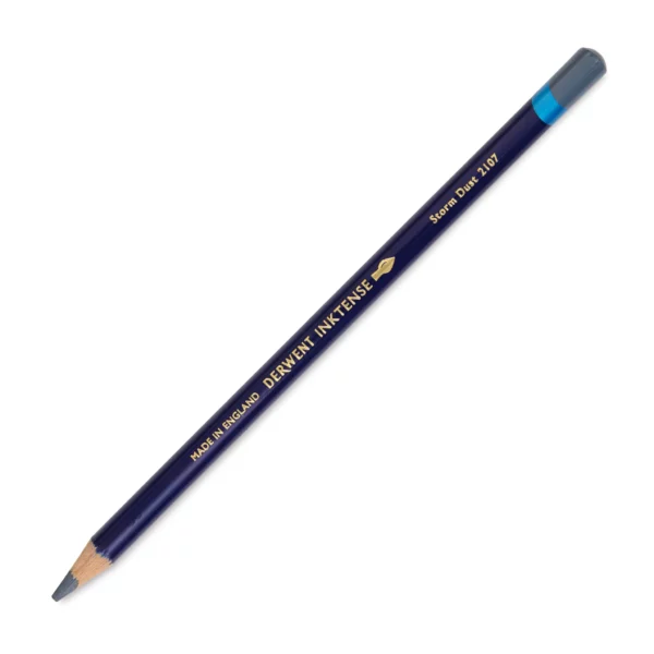 A single Storm Dust Derwent Inktense Colour Pencil is shown diagonally across the center of the frame. The pencil is pointing with it's lead facing towards the bottom left hand corner. The barrel of the pencil is blue and the end of the pencil is colour dipped to match the colour of the lead for easy identification. There is text down the barrel of the pencil with the colour name and brand name. On a white background.