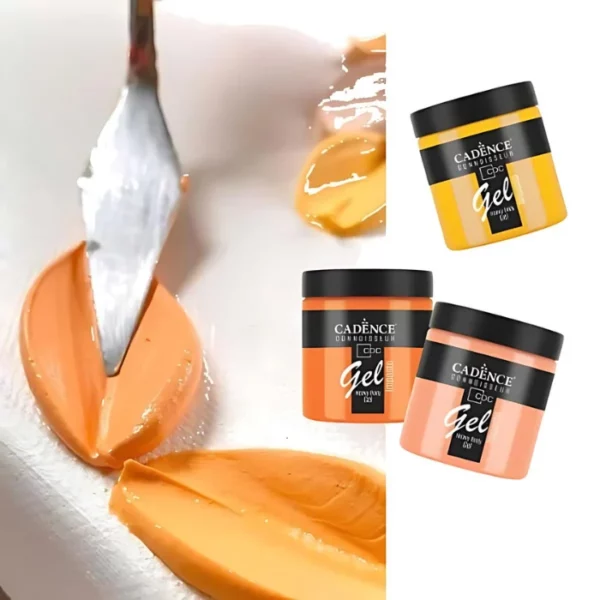 A promotional image for Cadence Connoissuer Heavy Body Gel Acrylics. A palette knife is seen coming in from the top of the frame, applying some paint peaks to a surface. The paint is orange. There are three jars of paint along the right hand side of the frame. they are oranges and ywllows.