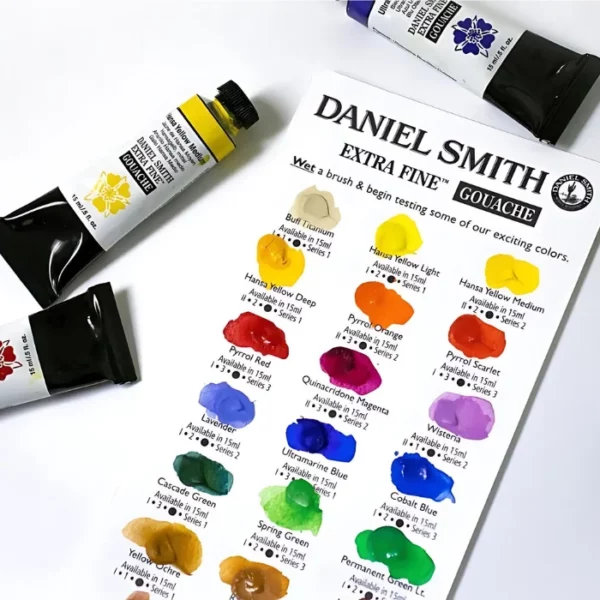 A colour swatch chart for the Daniel Smith Extra Fine Gouache Paints is shown in the frame, with a few tubes of gouache lying around the swatch chart. It is a close up and the image is cut off by the frame.