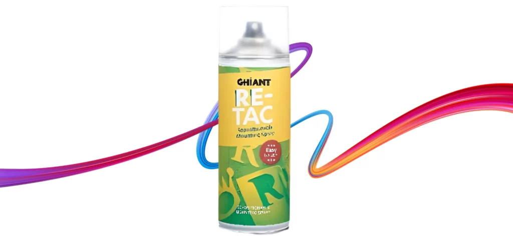 ghiant repositional spray adhesive is sitting in the center of the image. the can is a yellow colour at the top with the bottom being a green colour. the writing on the can is white. the lid is clear showing the white nizzle. it is sitting ona rainbow squiggle on a white background