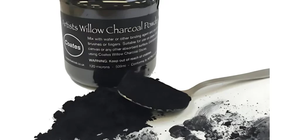 Coates Willow Charcoal Powder 500ml. Open tub with ground powder next to the tub and a spoon piled with the ground charcoal in front of the tub