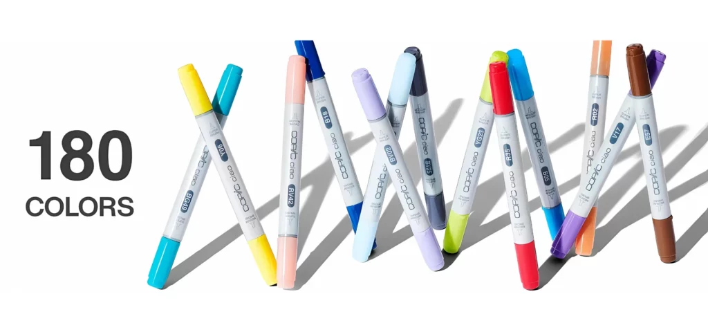 across the centre of the image are13 different coloured copic ciao markers all standing up and leaning in pairs or in groups of three. their shadows are showing behind them. to the left of them is the writing with the words 180 colors. on a white background.