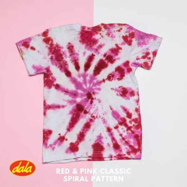 A pink tye dye t-shirt is shown in the frame. It is pink and white and the background is also pink and white. It has been dyed, using the Dala All-In-One Fabric Dyes.