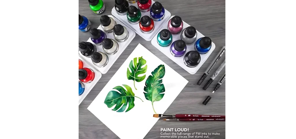 A promotional image for Daler Rowney FW Acrylic Inks. A birds eye view of a number of inks on a surface with a piece of paper that has a drawing of some green leaves. There are some paint brushes and markers around the inks. There are 20 different coloured ink bottles in the frame.