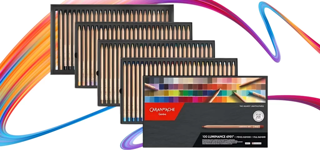 Set of 100 Caran D'Ache Luminance 6901 Coloured Pencils. An open box of pencils. The lid is overlapping the 4 trays below with the coloured pencils. The image is center of the frame on top of a rainbow squiggle and on a white background.