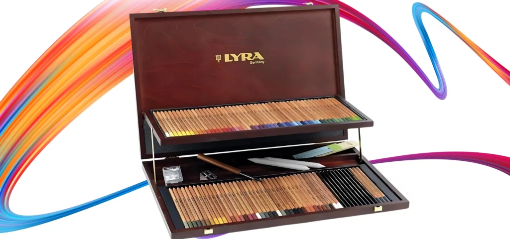 Lyra Rembrandt Polycolor Prestige Wooden Box Pencil Set. A front view of the wooden box set open. The set has 2 tiers and there are pencils in both tiers, as well as other items like kneadable eraser, sharpener, blending stumps etc. The box is slightly angled across the center of teh frame and is on a white background. The box is a dark wood and has the brand name printed on the inside of the lid.