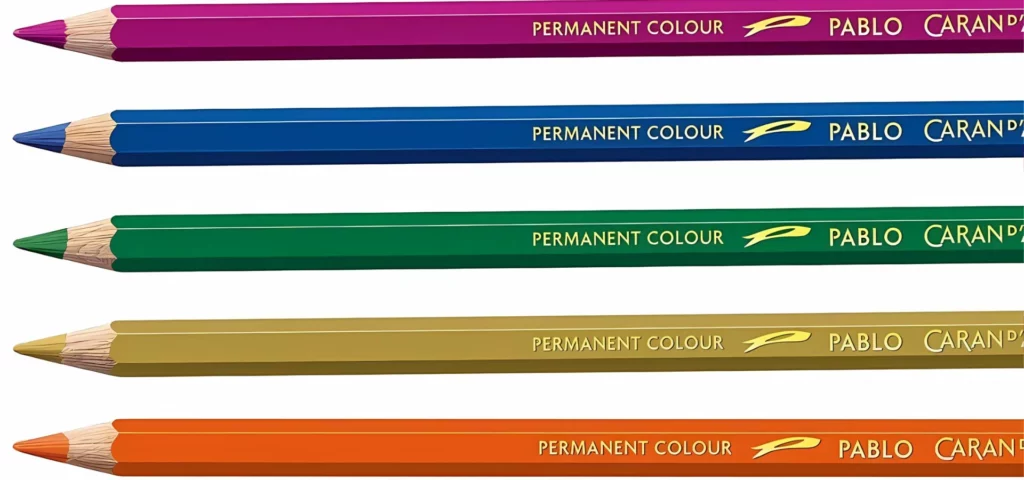 the pablo pencils are ln a horizontal line across the image. they are from top to bottom: purple, blue, green, yellow ochre and orange. their nibs are facing the left hand side of the image. their writing is clearly visable on each pencil in the center in gold. they are on a white background