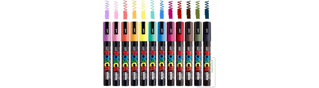 in the centre of the image are a rainbow selection of posca markers in a row. they are all facing upwards with their caps on. above thier cpas are little lines and dots showing the colour inside of each marker. on a white background